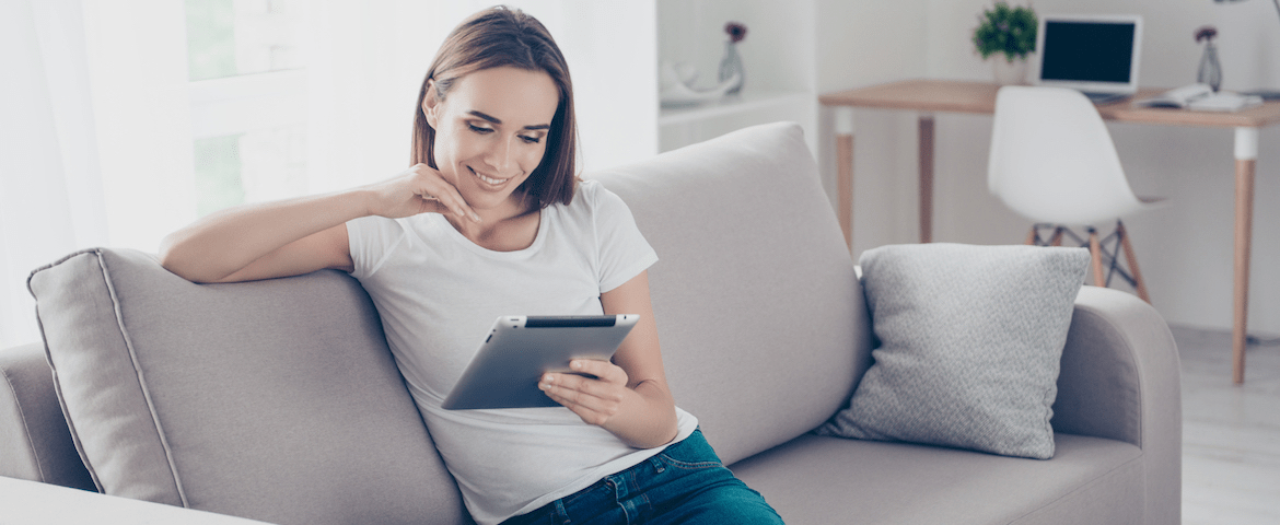 Woman looking at ipad on couch