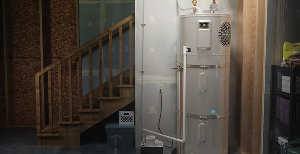 Water heater installed in a basement utility area near a wooden staircase, with pipes, wiring, and storage items around it