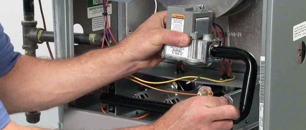 Dealer working on gas furnace valve