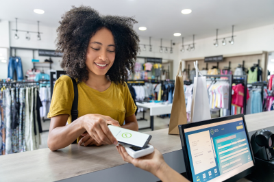 Young woman working at a cash counter in a retail store.